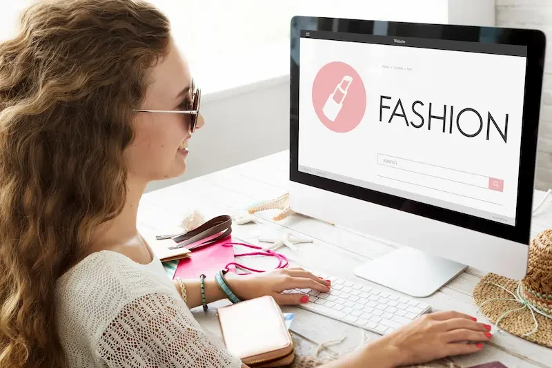Woman browsing apparel online with category-focused marketing.