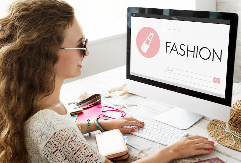 Woman browsing apparel online with category-focused marketing.